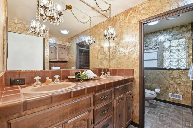 a view of a kitchen with a wooden floor and a ceiling fan