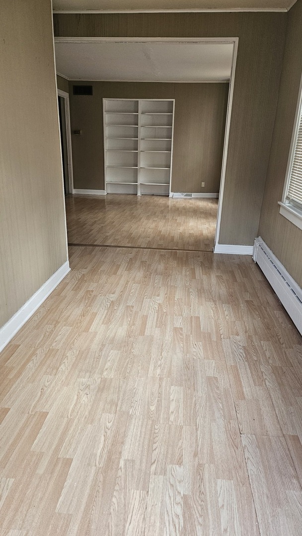 4238 Joliet Avenue, Unit 1R Lyons, IL 60534 - Photo 2 of 9 a view of empty room with wooden floor and fan