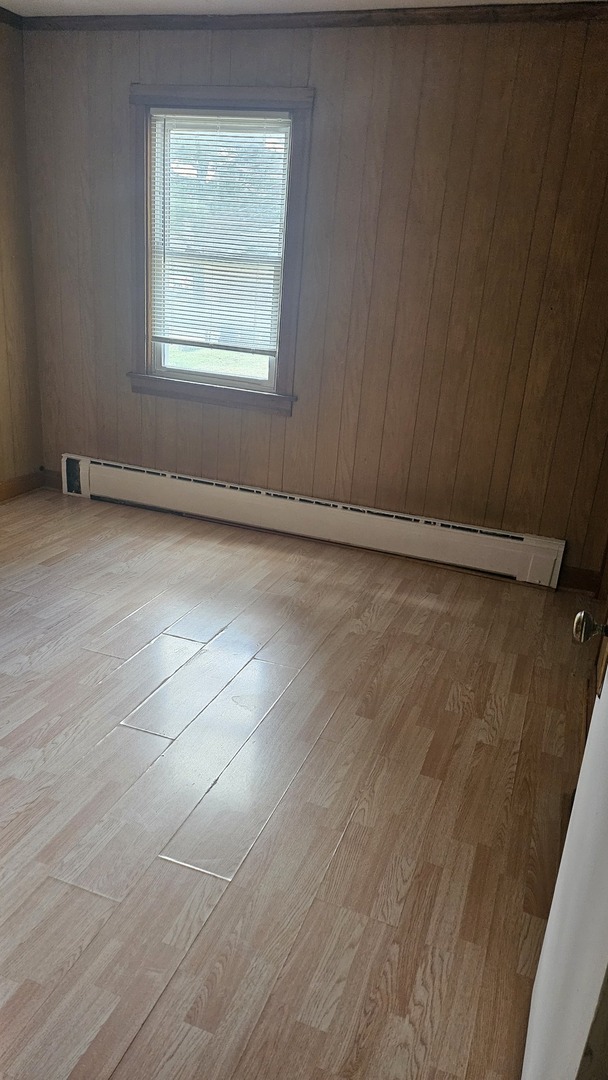 4238 Joliet Avenue, Unit 1R Lyons, IL 60534 - Photo 4 of 9 an empty room with wooden floor and windows