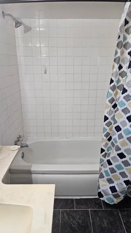 a bathroom with a bathtub and shower