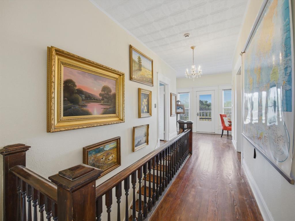 907 4th Street Graham, TX 76450 - Photo 16 of 34 a view of a hallway with wooden floor and staircase