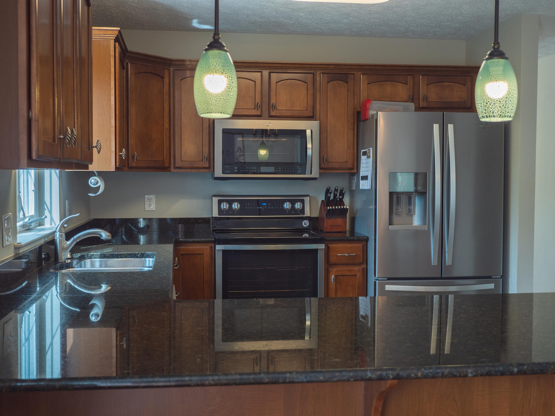 1124 Union Valley Road Riner, VA 24149 - Photo 3 of 67 a kitchen with kitchen island granite countertop a refrigerator a stove and a sink with wooden floor