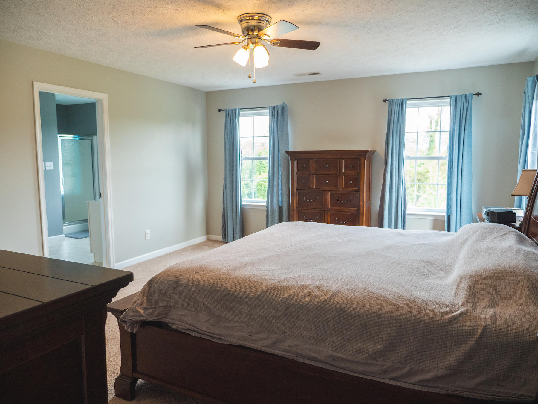 1124 Union Valley Road Riner, VA 24149 - Photo 28 of 67 a bedroom with a bed and a chandelier