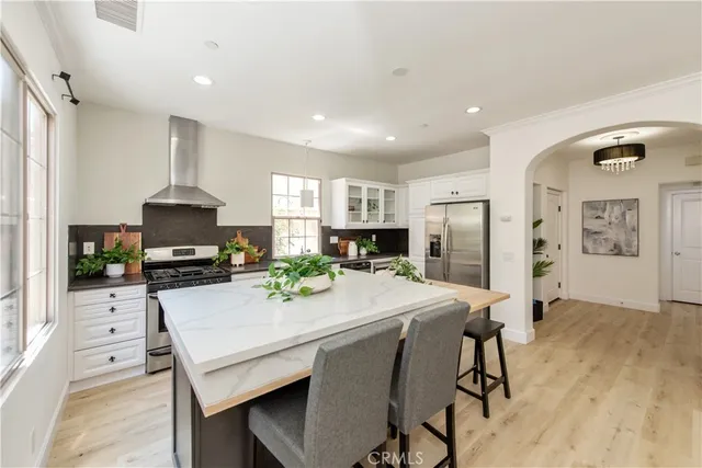 a kitchen with a dining table chairs refrigerator and cabinets