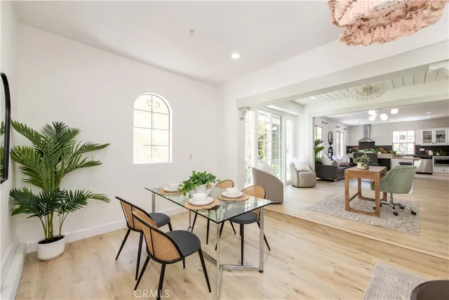 a view of a livingroom and dining room with furniture window and wooden floor