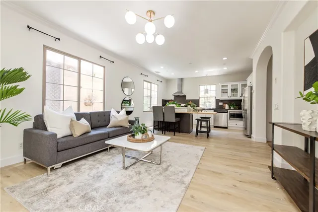 a living room with furniture and view of kitchen
