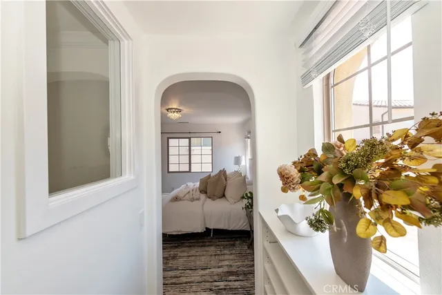 a bedroom with a bed and a potted plant