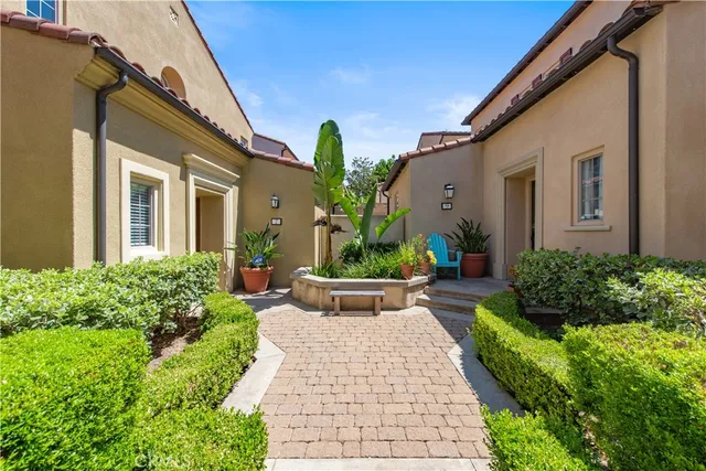 a view of a house with potted plants