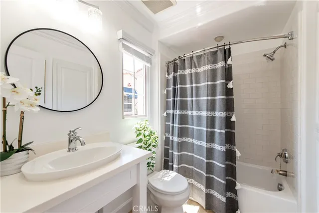 a bedroom with a bed and a potted plant