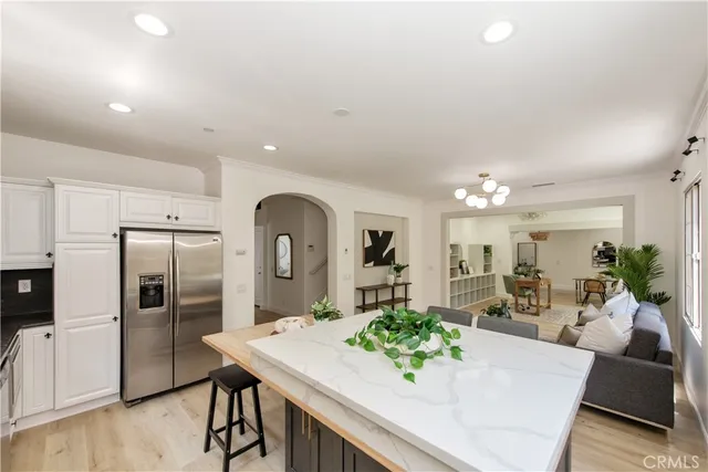 a kitchen with stainless steel appliances kitchen island granite countertop a table and chairs in it