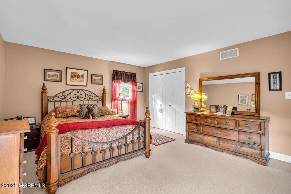460 Alexander Avenue Howell, NJ 07731 - Photo 10 of 14 a bedroom with a bed and a lamp on dresser