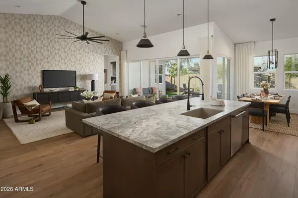 a kitchen with cabinets and chairs