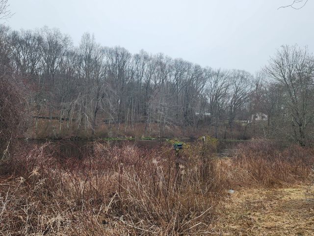 a view of a house with a yard and wooden fence