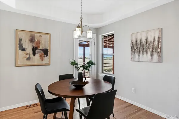 a view of a dining room with furniture wooden floor and a chandelier