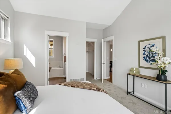 a bedroom with a bed and a couch
