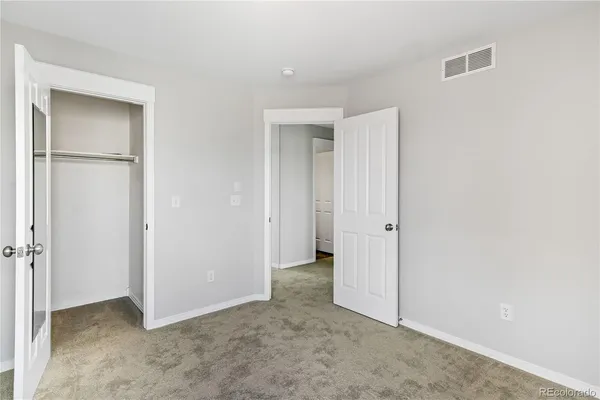 an empty room with closet area