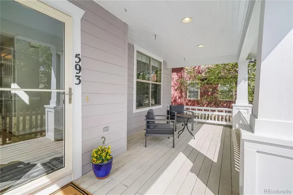 a view of a two chair in the patio with potted plants