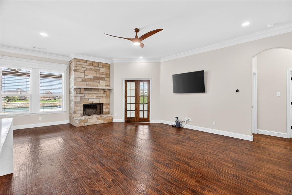 7320 Spring Ranch Court Godley, TX 76044 - Photo 14 of 38 an empty room with wooden floor fireplace and windows