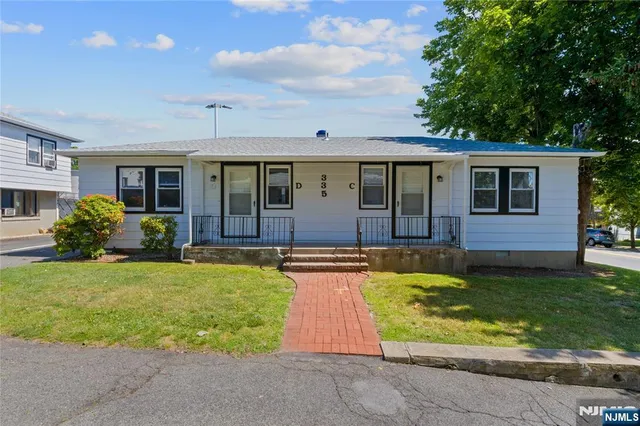 a view of swimming pool with small yard and plants