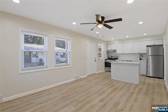 a view of kitchen with cabinets and wooden floor