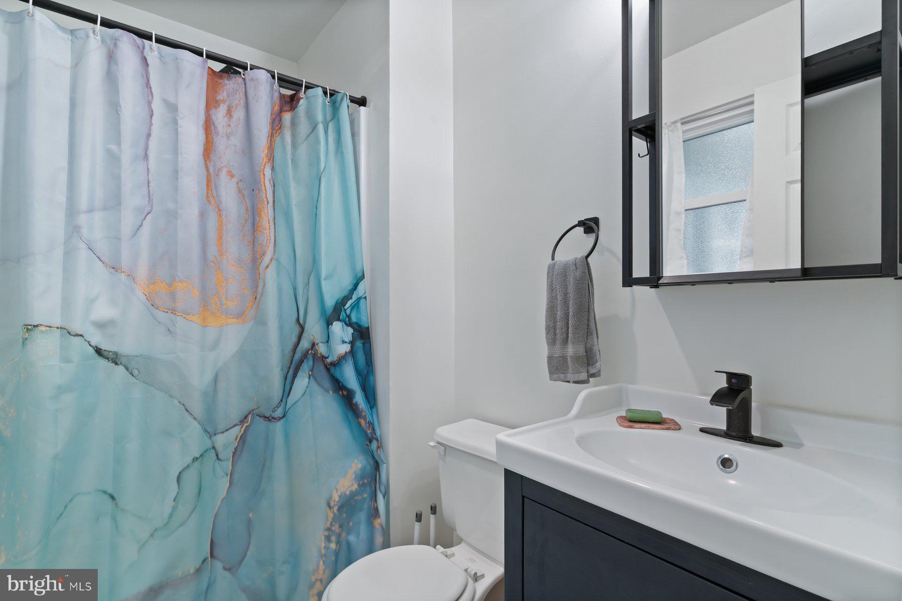 6571 11th Street Chesapeake Beach, MD 20732 - Photo 12 of 36 a bathroom with a sink toilet and shower