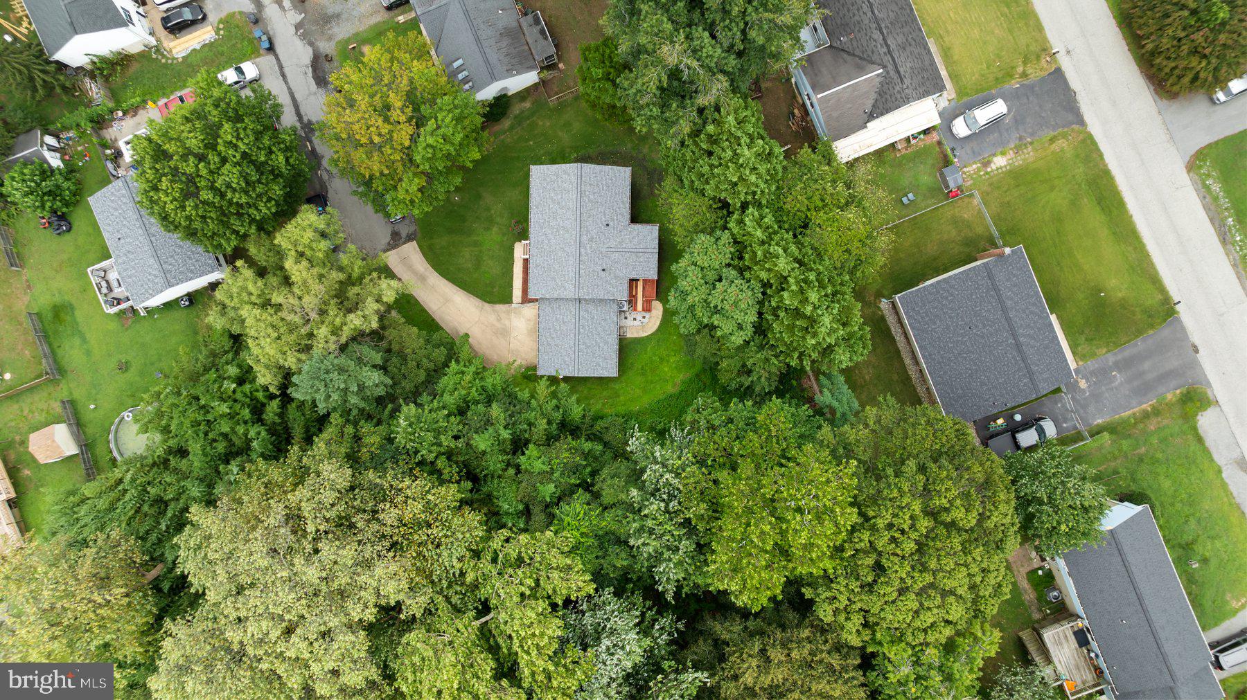 6571 11th Street Chesapeake Beach, MD 20732 - Photo 30 of 36 an aerial view of a house with a yard and trees