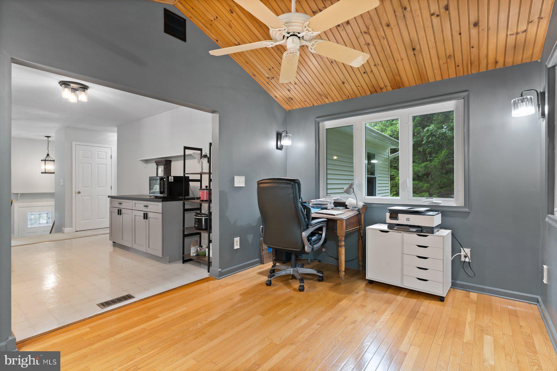 6571 11th Street Chesapeake Beach, MD 20732 - Photo 8 of 36 a view of a workspace with furniture and a window