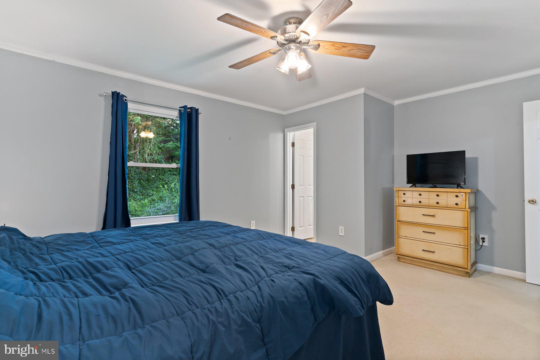6571 11th Street Chesapeake Beach, MD 20732 - Photo 10 of 36 a bedroom with a bed and a flat screen tv