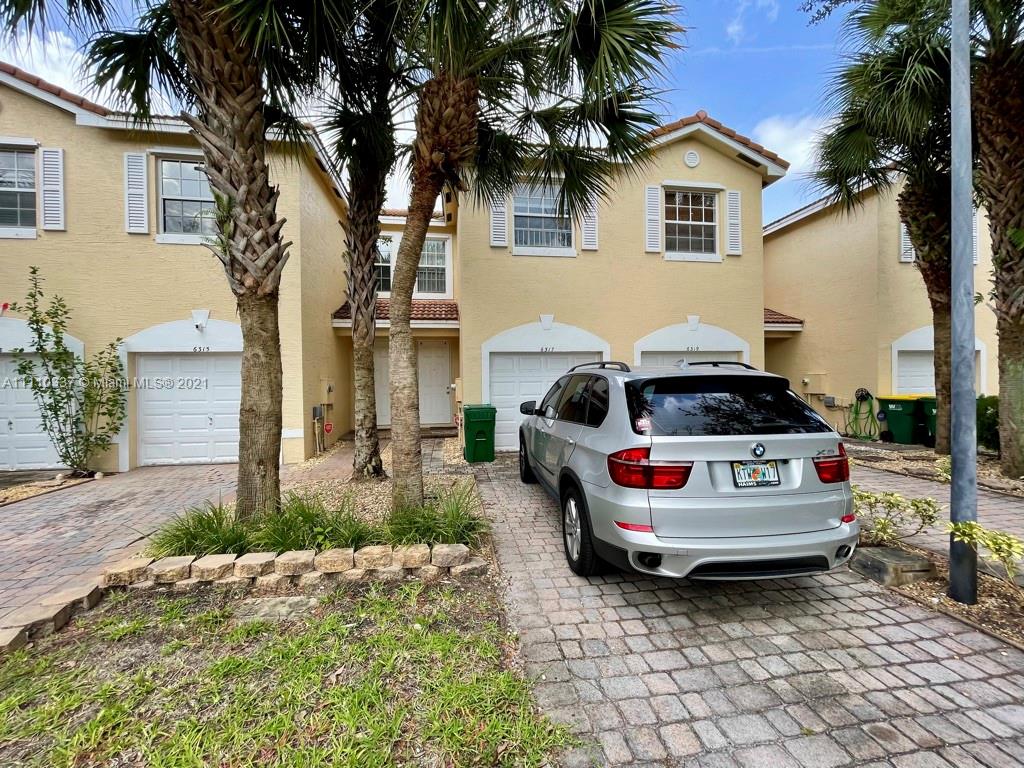 6317 Landings Terrace Tamarac, FL 33321 - Photo 1 of 20 a car parked in front of a house