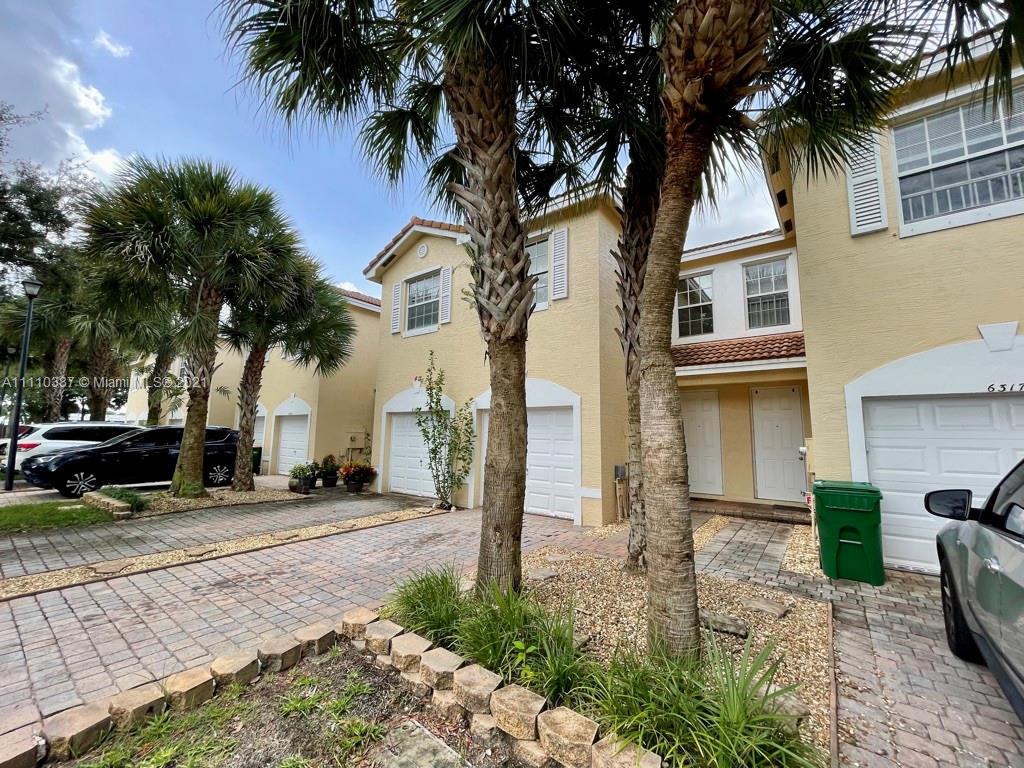 6317 Landings Terrace Tamarac, FL 33321 - Photo 2 of 20 a couple of cars parked in front of a house