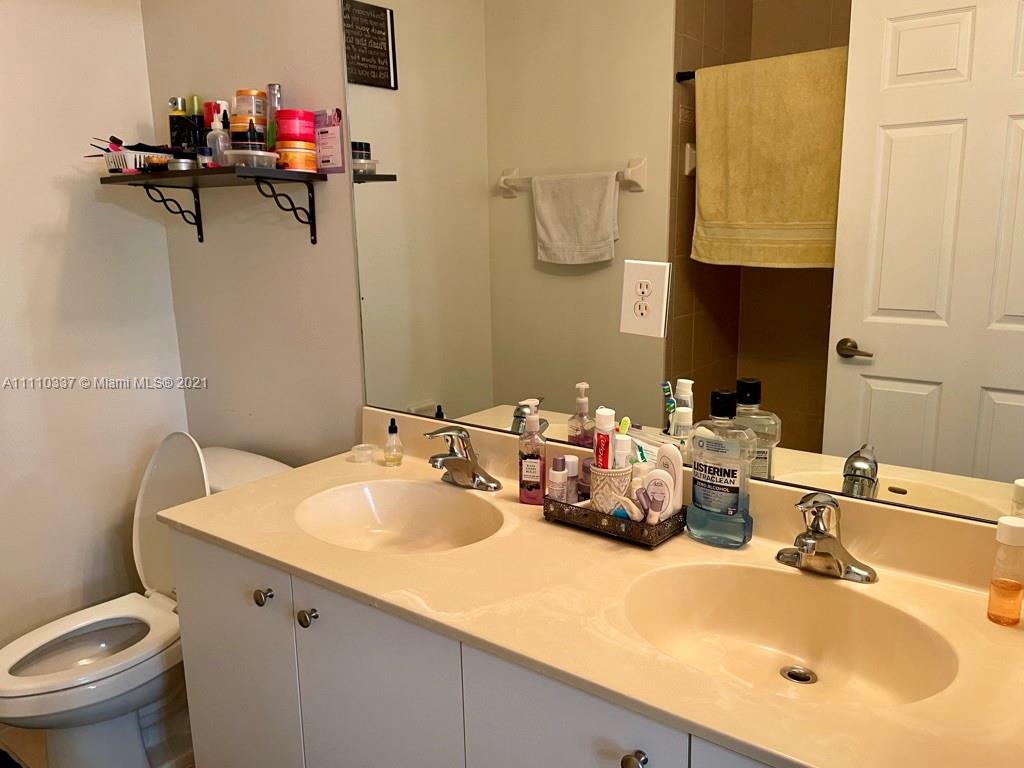 6317 Landings Terrace Tamarac, FL 33321 - Photo 11 of 20 a bathroom with a sink double vanity and a toilet