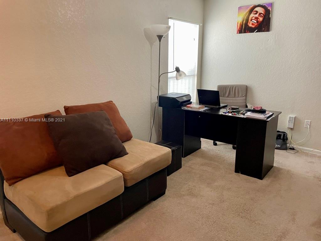 6317 Landings Terrace Tamarac, FL 33321 - Photo 12 of 20 a living room with furniture and a desk