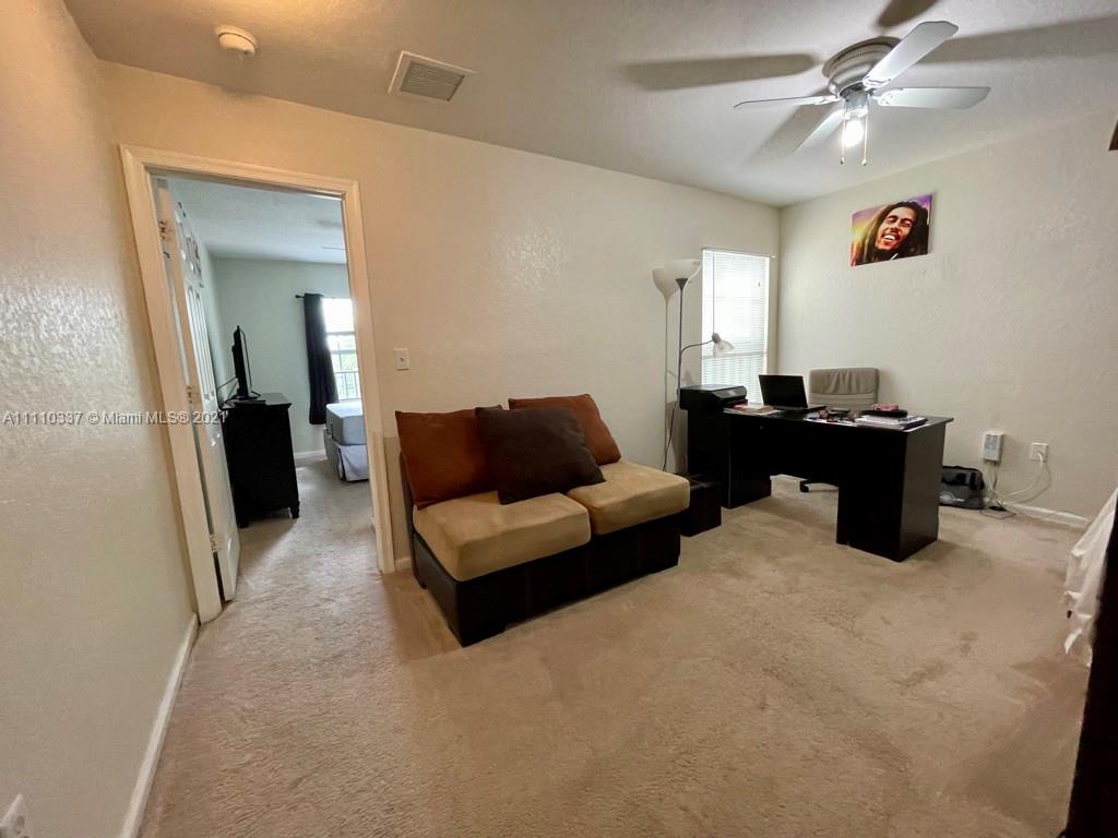 6317 Landings Terrace Tamarac, FL 33321 - Photo 13 of 20 a living room with furniture and a chandelier