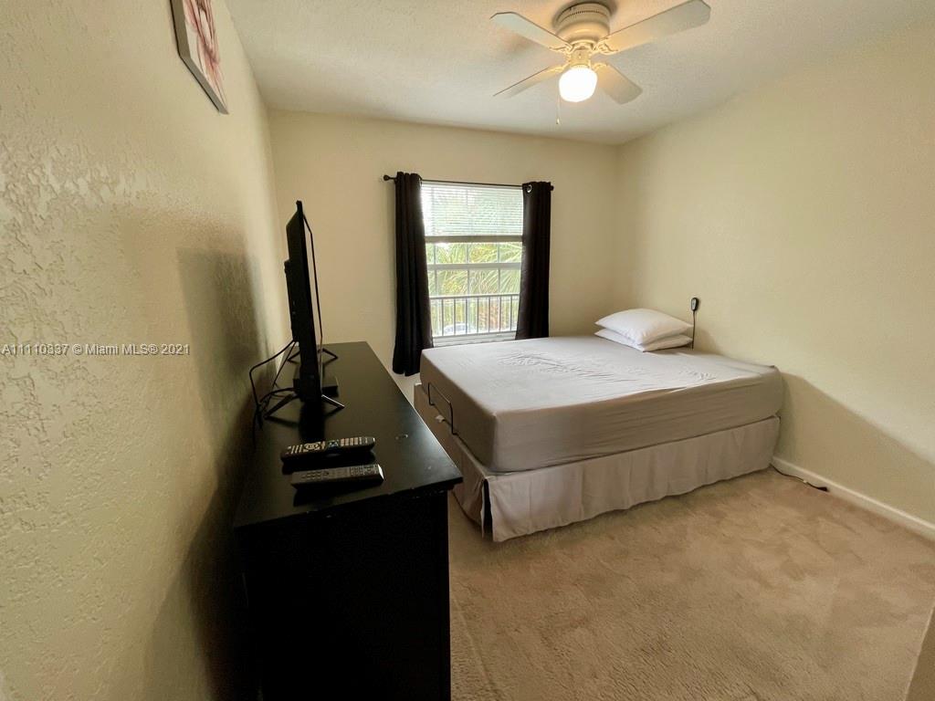 6317 Landings Terrace Tamarac, FL 33321 - Photo 15 of 20 a bedroom with a bed and a window