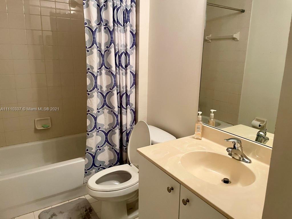 6317 Landings Terrace Tamarac, FL 33321 - Photo 17 of 20 a bathroom with a sink a toilet and a bathtub