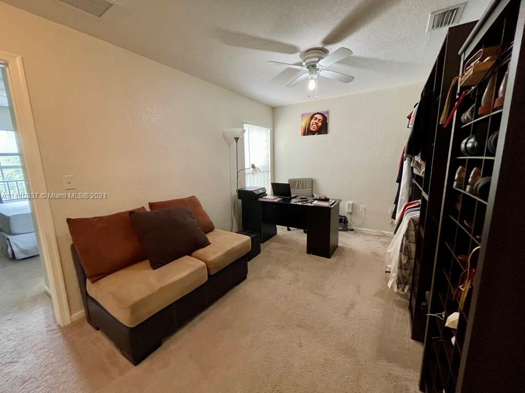 6317 Landings Terrace Tamarac, FL 33321 - Photo 19 of 20 a living room with furniture and a flat screen tv