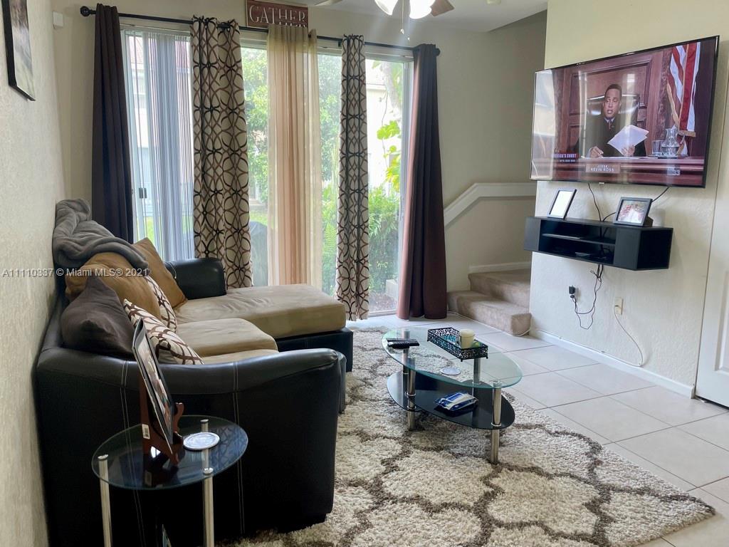 6317 Landings Terrace Tamarac, FL 33321 - Photo 3 of 20 a living room with furniture and a flat screen tv