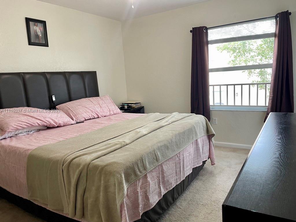 6317 Landings Terrace Tamarac, FL 33321 - Photo 9 of 20 a bedroom with a bed and a window