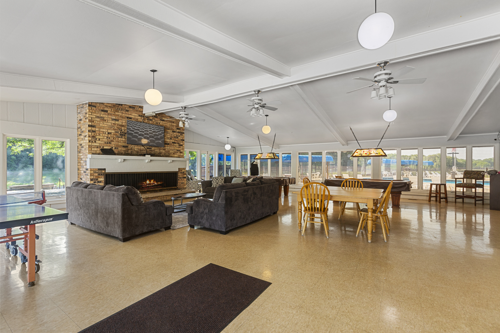 58 Vail Colony, Unit 10 Fox Lake, IL 60020 - Photo 17 of 28 a living room with furniture a chandelier and a fireplace