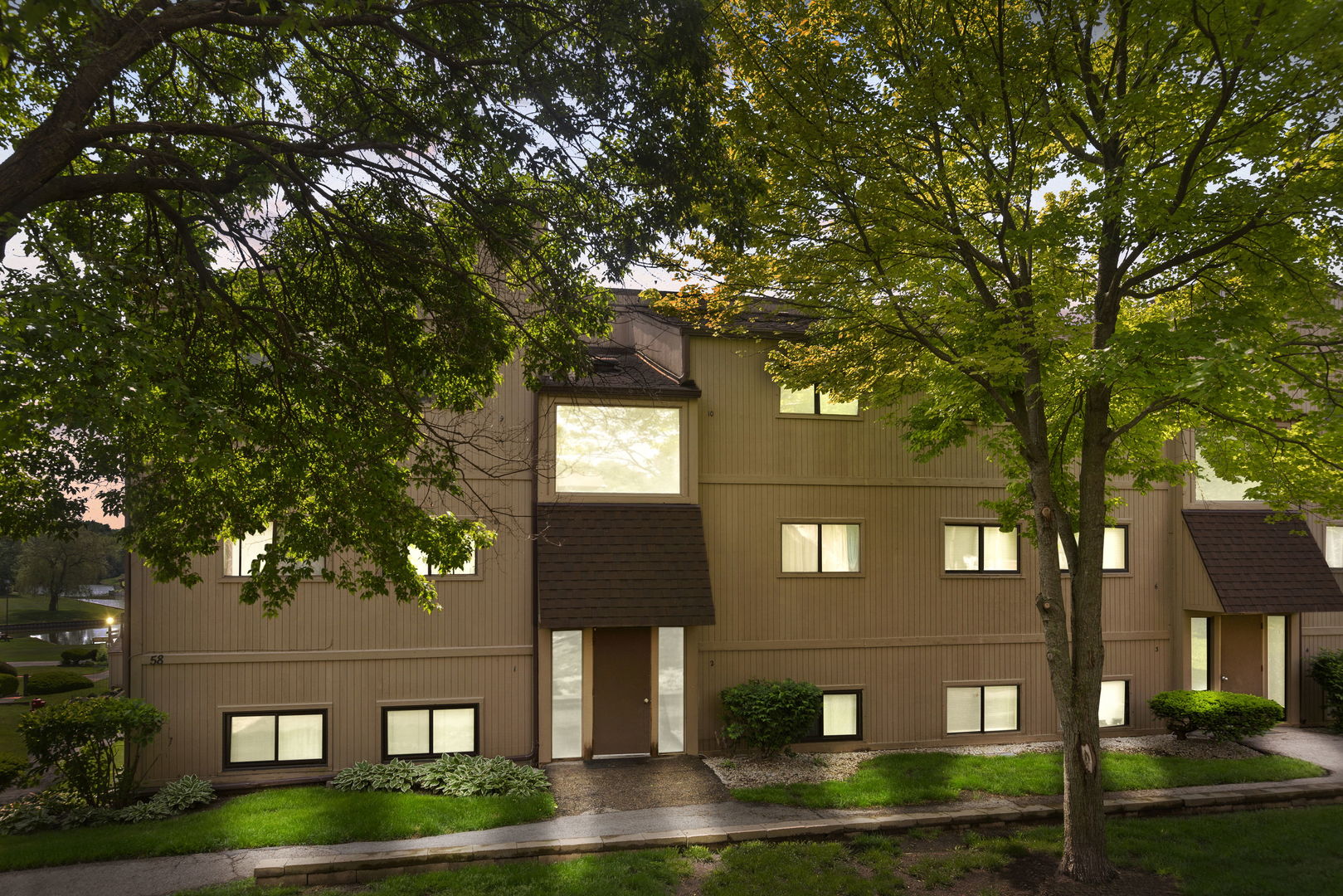 58 Vail Colony, Unit 10 Fox Lake, IL 60020 - Photo 2 of 28 a front view of a house with garden