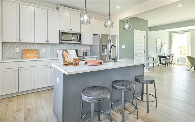 113 Affinity Drive Harmony, PA 16037 - Photo 2 of 40 a kitchen with stainless steel appliances granite countertop a stove a sink a dining table and chairs with wooden floor