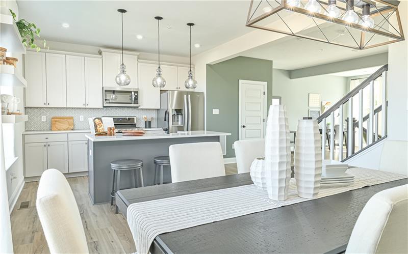 113 Affinity Drive Harmony, PA 16037 - Photo 3 of 40 a kitchen with stainless steel appliances kitchen island granite countertop a table chairs and a refrigerator