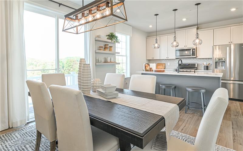 113 Affinity Drive Harmony, PA 16037 - Photo 7 of 40 a dining room with stainless steel appliances granite countertop a table chairs and a window