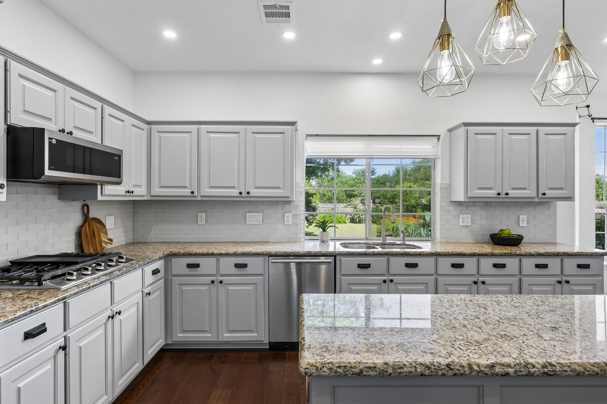 6557 Needham Lane Austin, TX 78739 - Photo 8 of 37 Renovated kitchen at with views of the backyard oasis