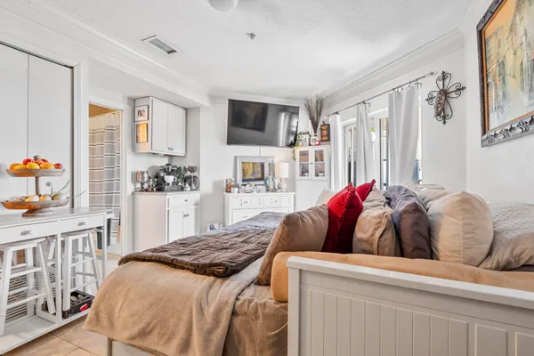 a bedroom with a bed and a flat screen tv in it