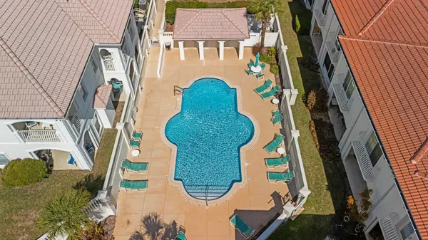 a living room with furniture a flat screen tv and a large window