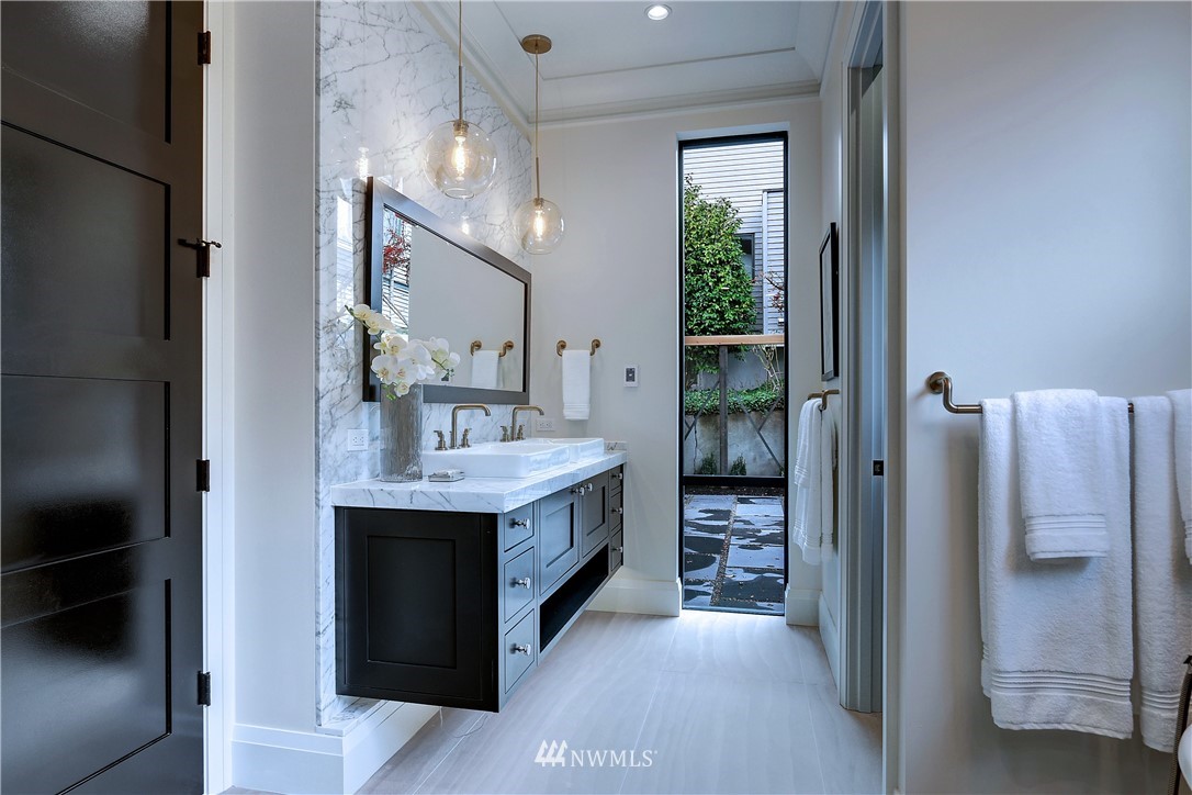 362 Ward Street Seattle, WA 98109 - Photo 18 of 40 a bathroom with a double vanity sink and a mirror