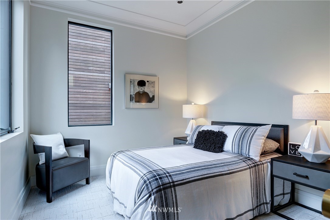 362 Ward Street Seattle, WA 98109 - Photo 22 of 40 a bedroom with a bed and lamp