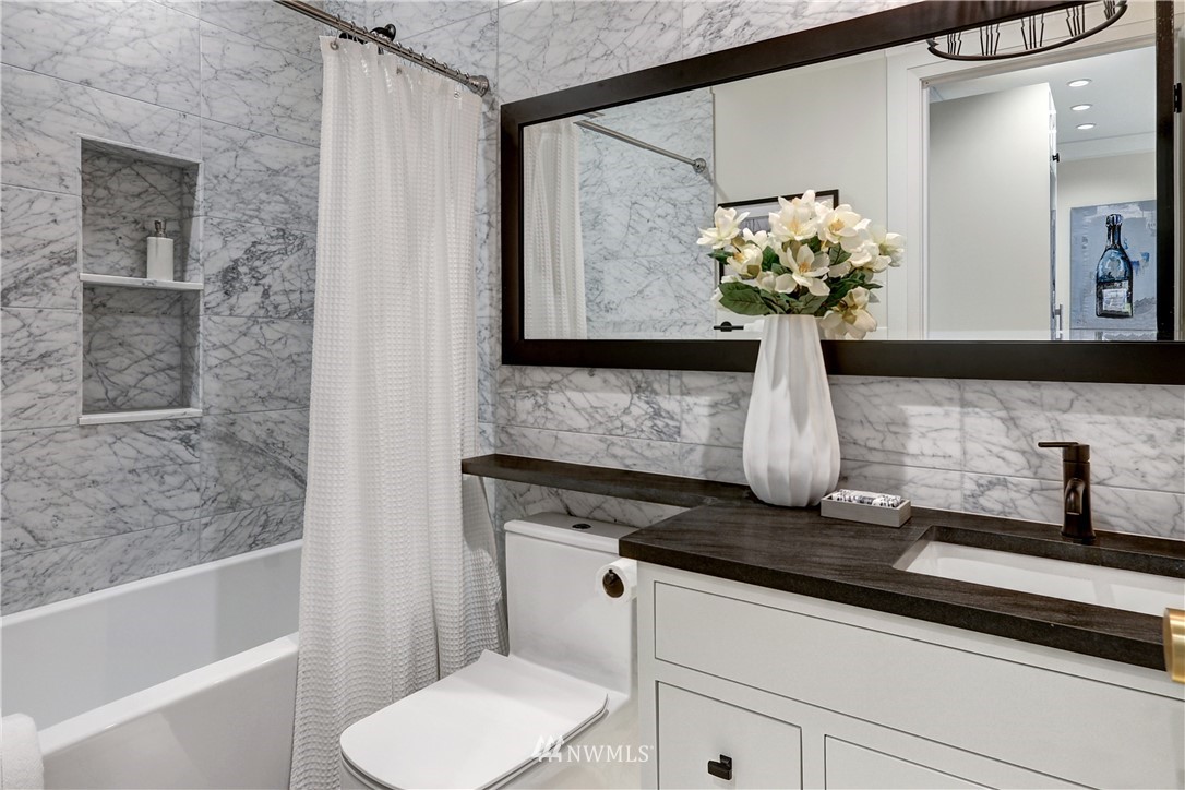 362 Ward Street Seattle, WA 98109 - Photo 28 of 40 a bathroom with a sink a toilet and shower