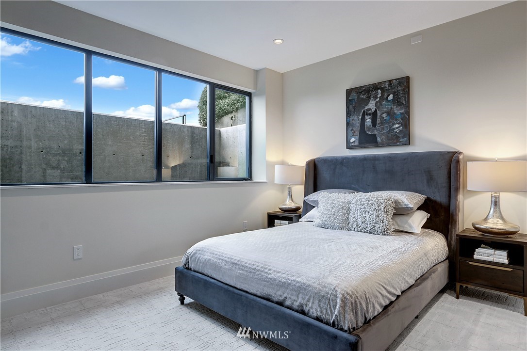 362 Ward Street Seattle, WA 98109 - Photo 29 of 40 a bedroom with a large bed and a large window